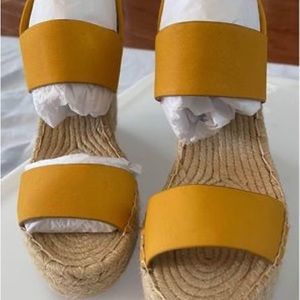 This is a soft yellow platform sandal with a tweed insole